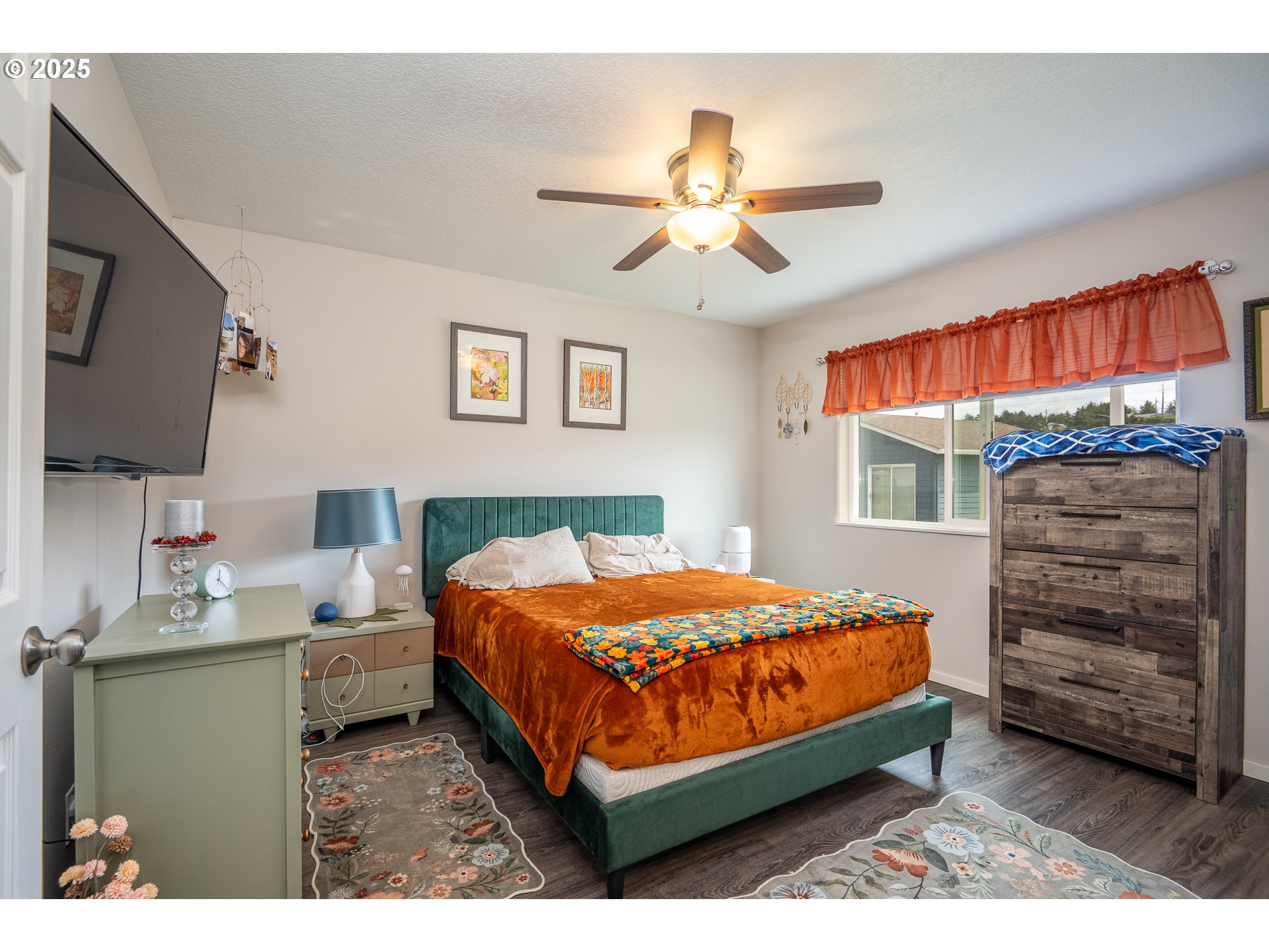 1602 Northwest Oceanic Loop Waldport, OR 97394 - Photo 19 of 47 a bedroom with a bed a dresser and a window
