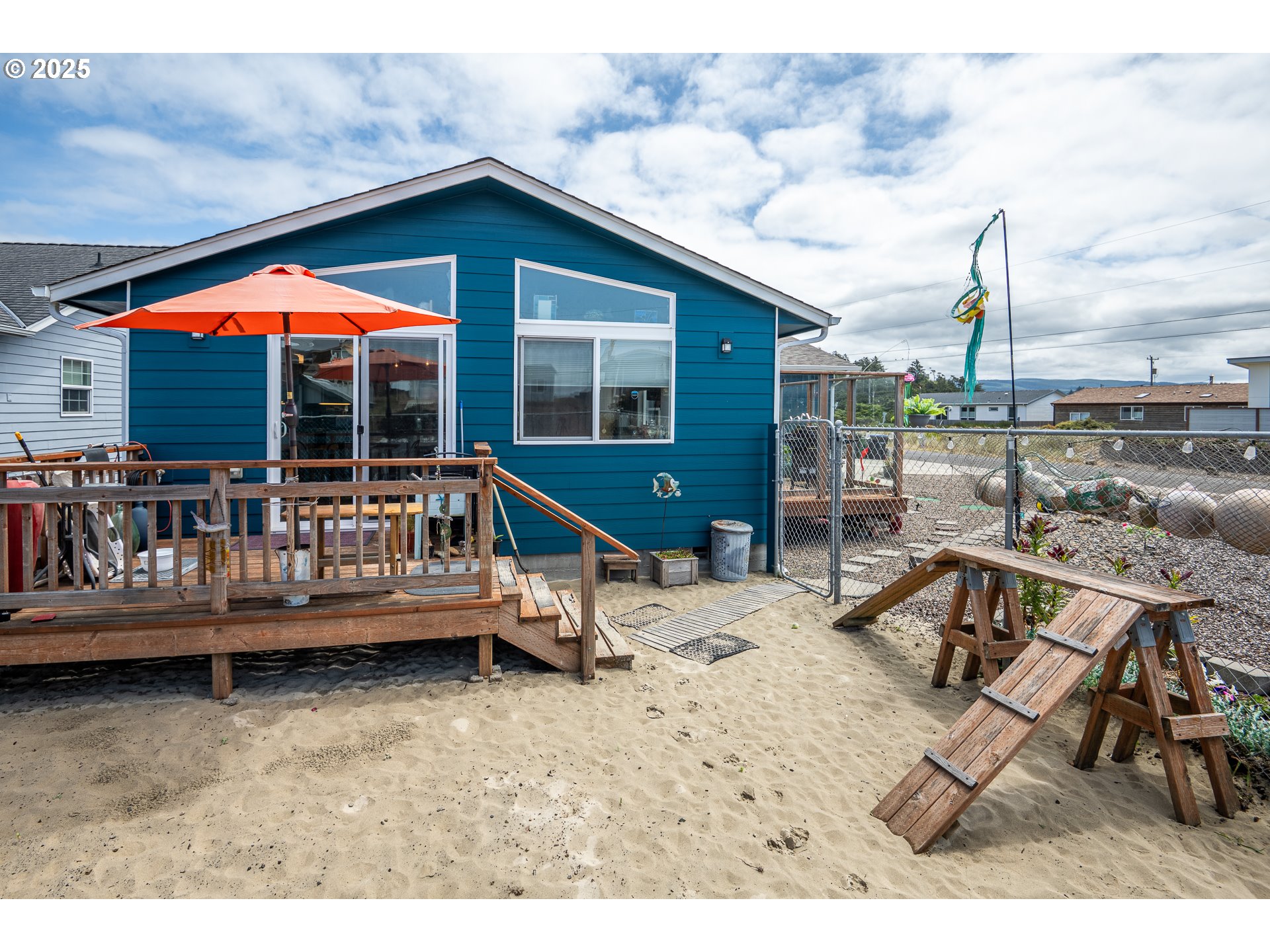 1602 Northwest Oceanic Loop Waldport, OR 97394 - Photo 29 of 47 a view of a house with a wooden deck