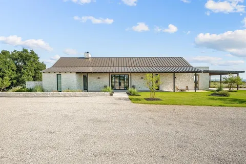 a view of house with outdoor space and parking