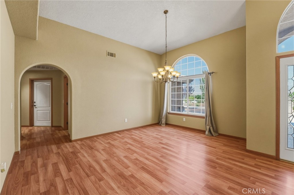 19501 Kinai Road Apple Valley, CA 92307 - Photo 9 of 49 a view of a room with wooden floor chandelier and a window