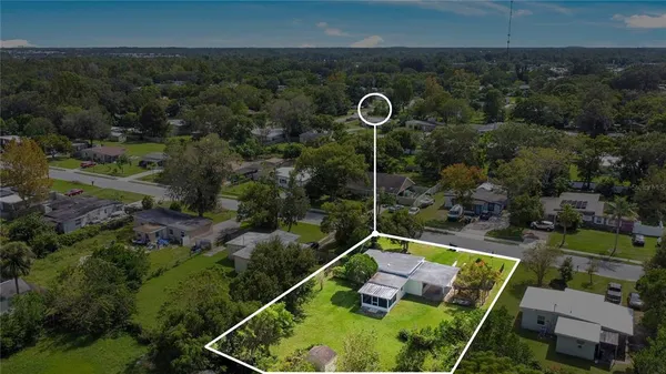 a view of a backyard with plants and swimming pool