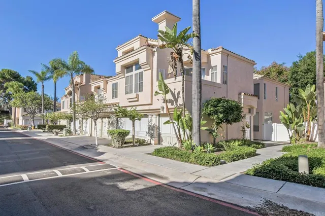 a front view of multiple houses with yard