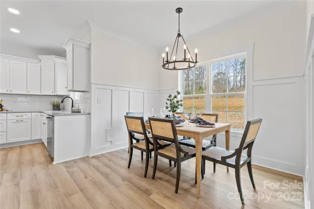 a kitchen with stainless steel appliances granite countertop a stove a sink dishwasher and a refrigerator with wooden cabinets