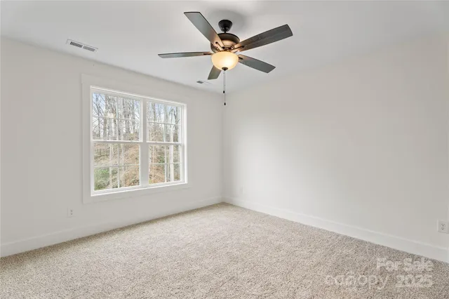a view of a house with backyard and trees