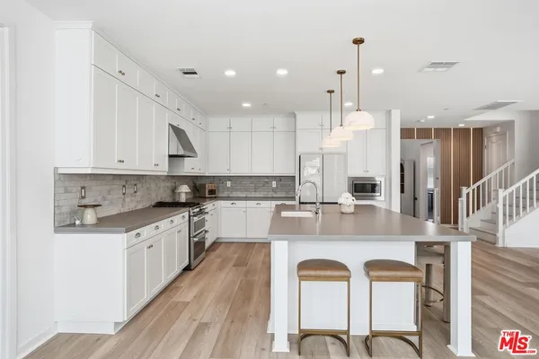 a kitchen with a sink a stove and refrigerator