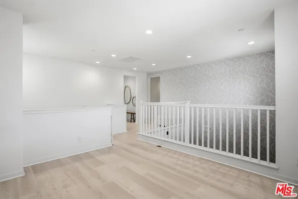 a bedroom with a bed couch and a flat tv screen