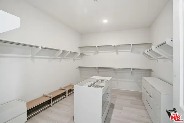 a bedroom with a bed and a night stand