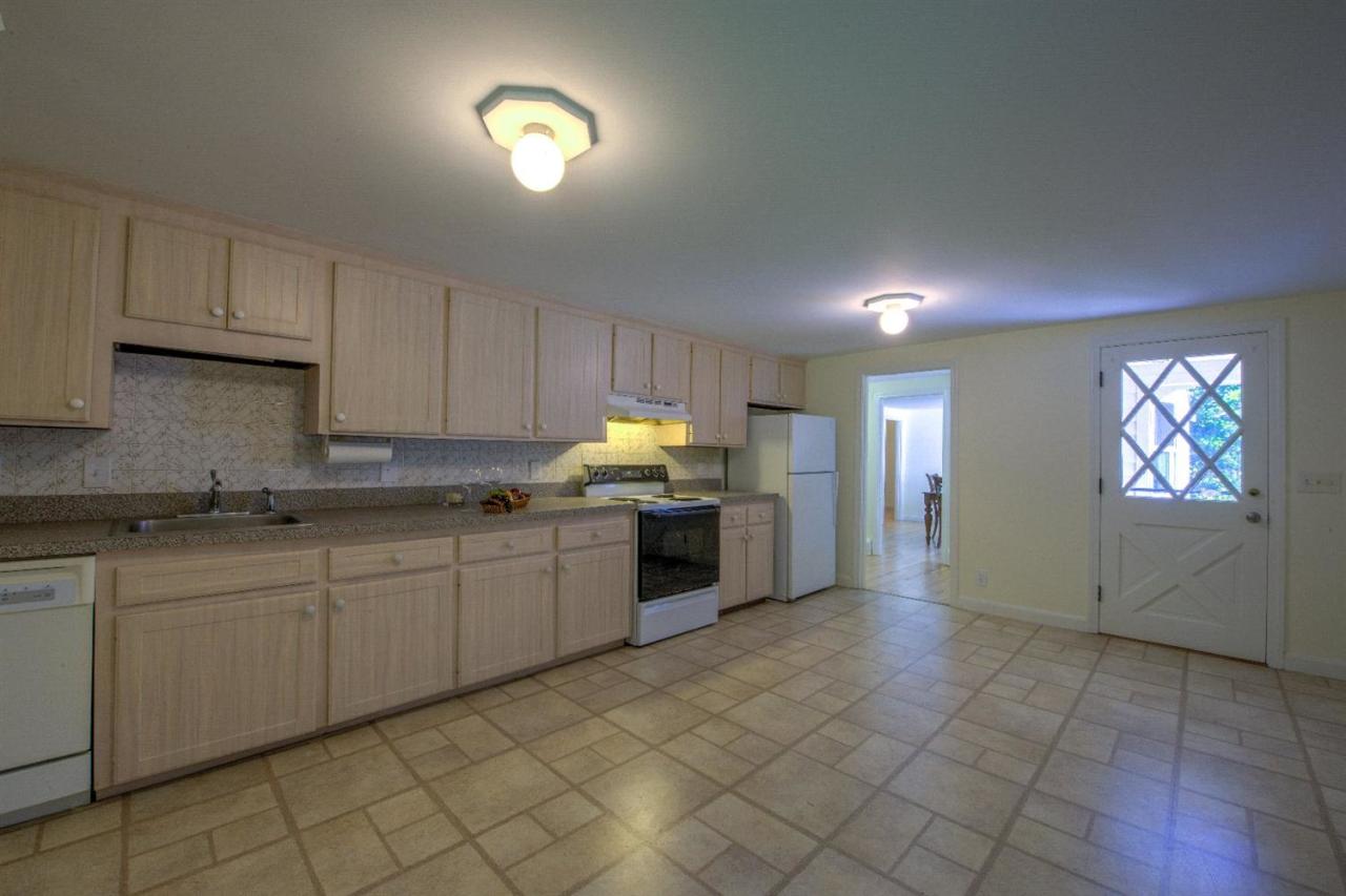 90 Ralyn Road Cotuit, MA 02635 - Photo 11 of 29 a kitchen with stainless steel appliances granite countertop a stove sink and cabinets