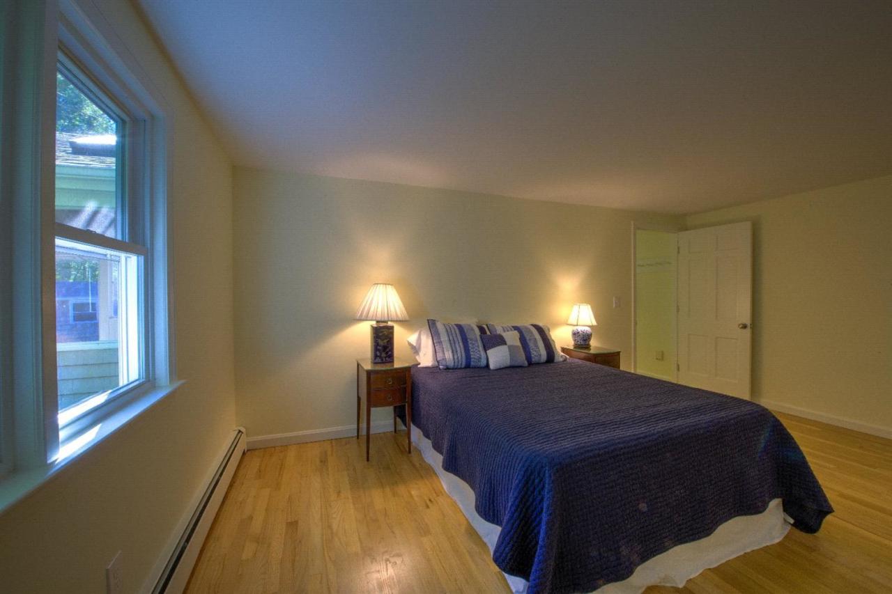 90 Ralyn Road Cotuit, MA 02635 - Photo 13 of 29 a bedroom with a bed and a lamp next to a window