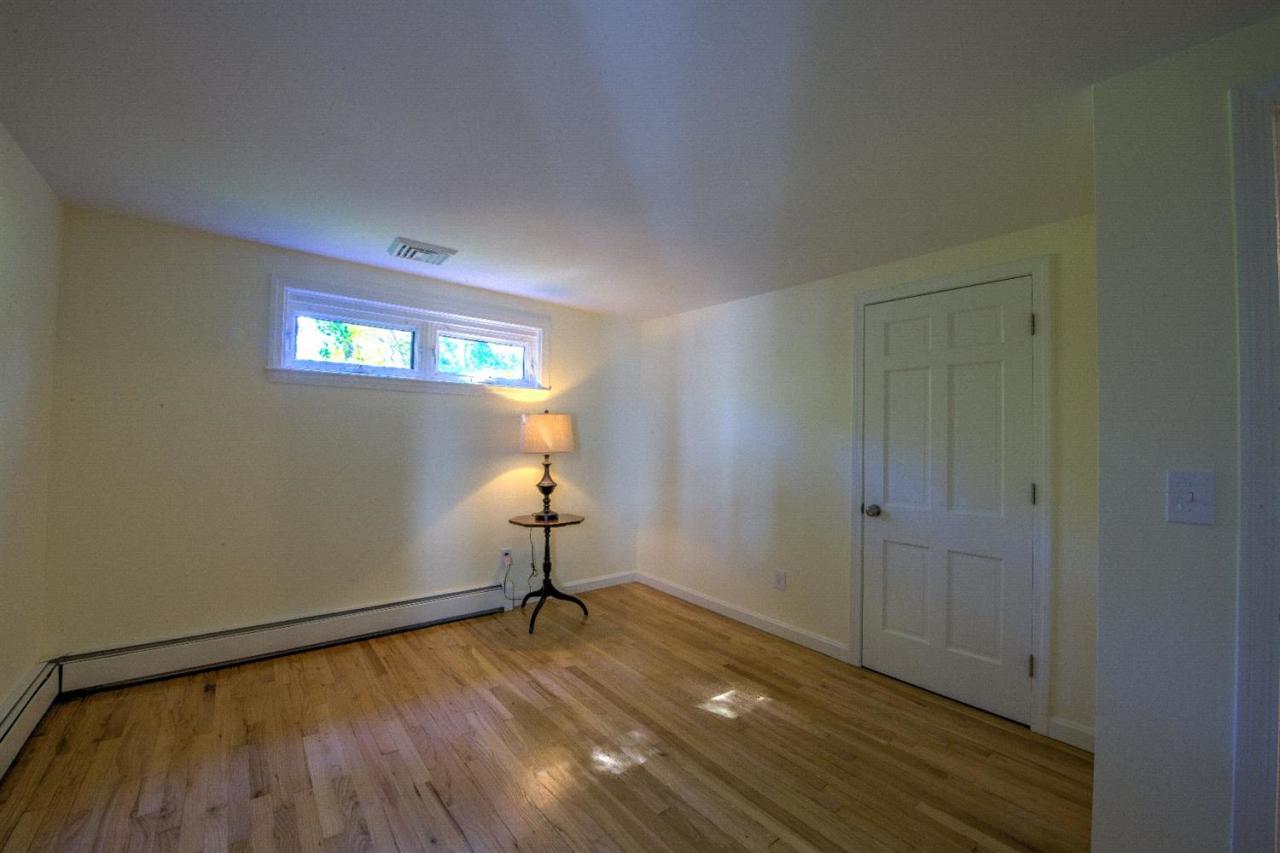 90 Ralyn Road Cotuit, MA 02635 - Photo 16 of 29 a view of empty room with wooden floor and fan