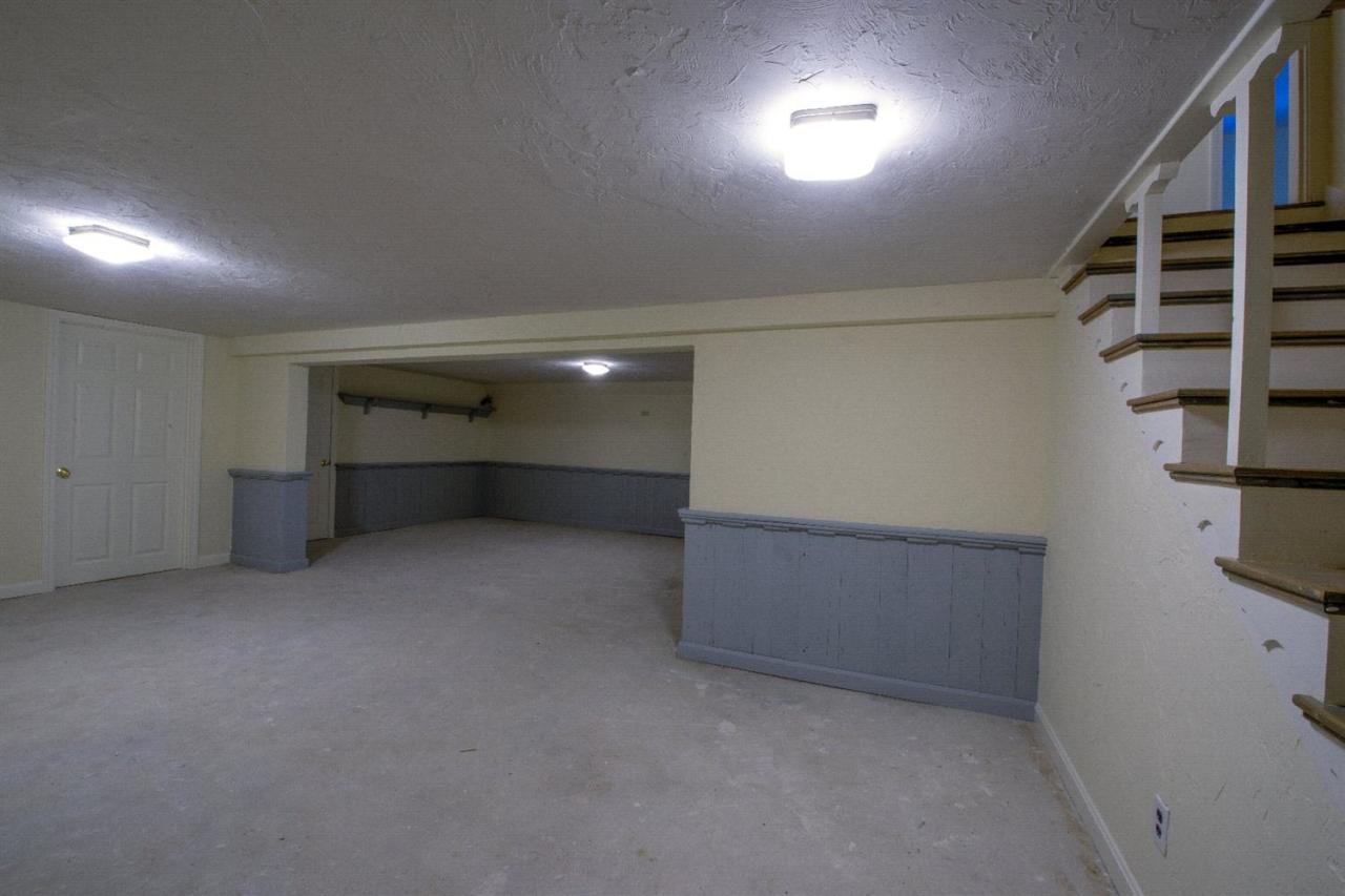 90 Ralyn Road Cotuit, MA 02635 - Photo 18 of 29 an empty room with windows and cabinet