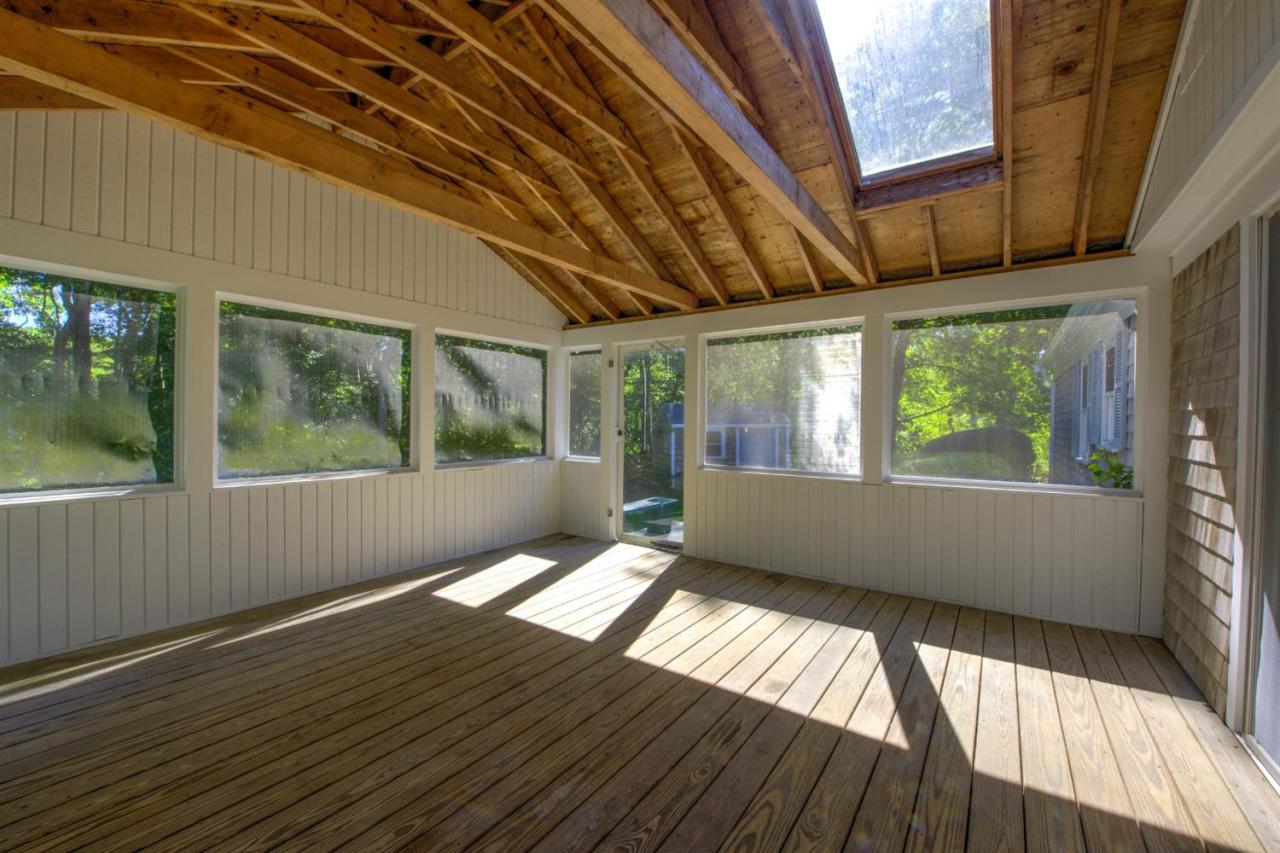 90 Ralyn Road Cotuit, MA 02635 - Photo 19 of 29 a view of an empty room with wooden floor and a window