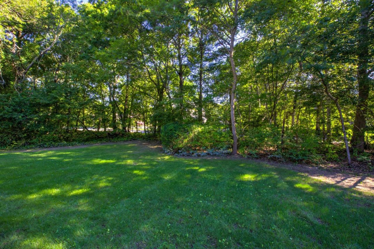 90 Ralyn Road Cotuit, MA 02635 - Photo 24 of 29 a view of green field with trees in the background