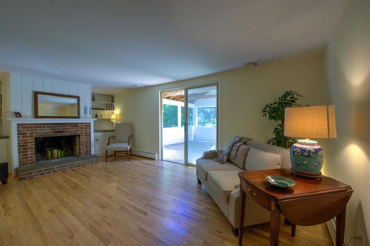 90 Ralyn Road Cotuit, MA 02635 - Photo 4 of 29 a living room with furniture and a fireplace