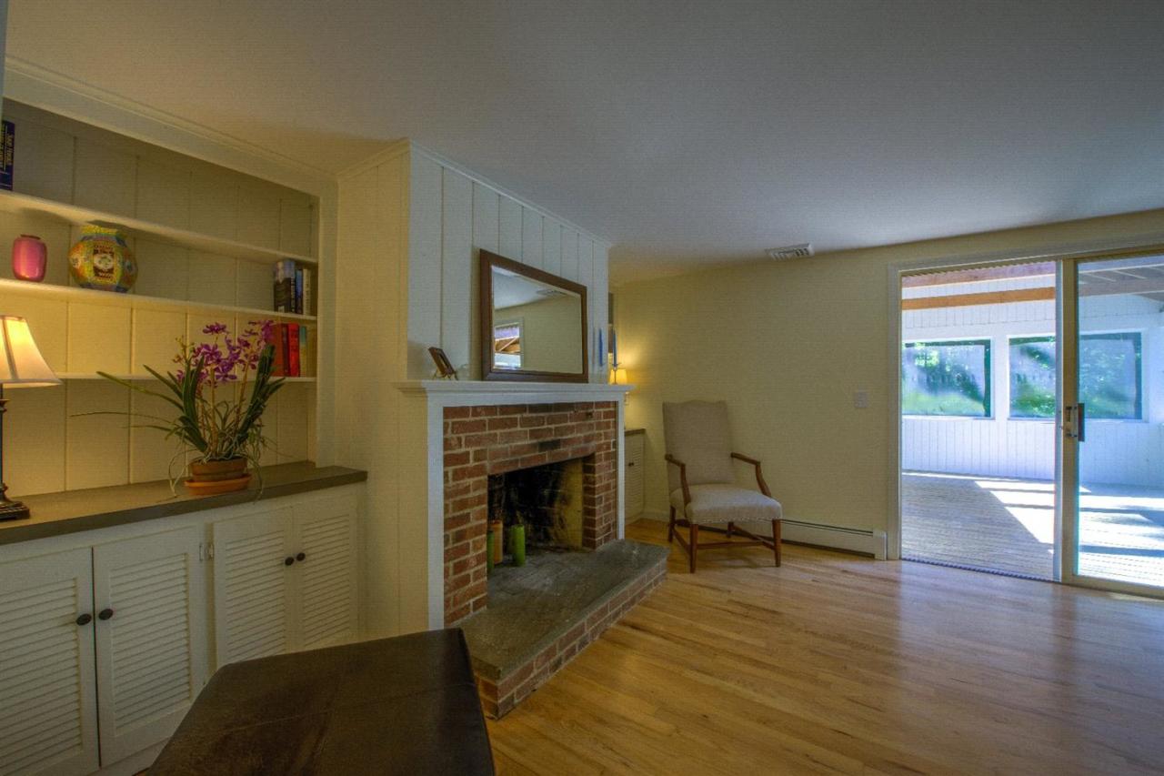 90 Ralyn Road Cotuit, MA 02635 - Photo 5 of 29 a living room with furniture a fireplace and a flat screen tv