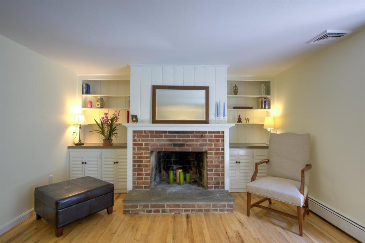 90 Ralyn Road Cotuit, MA 02635 - Photo 6 of 29 a living room with furniture and a fireplace