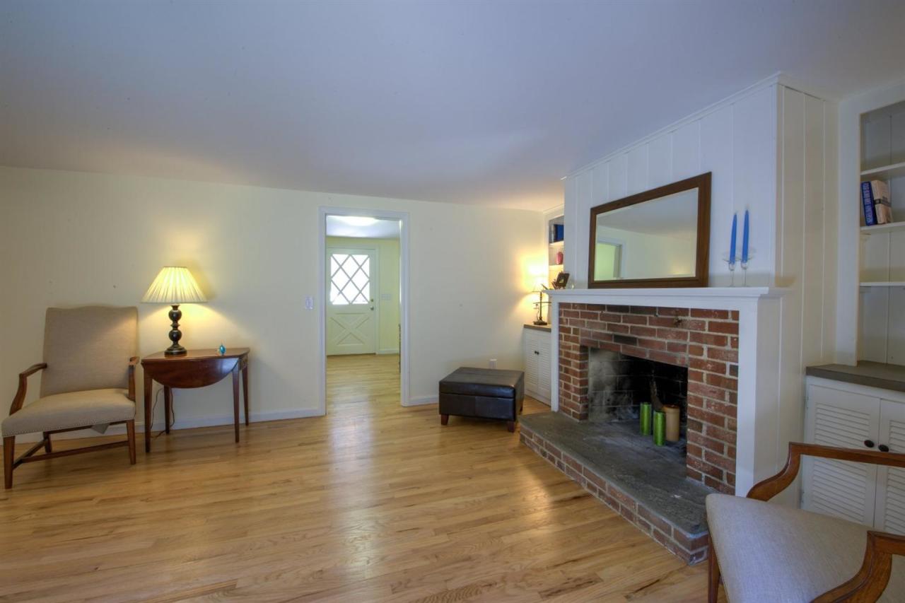 90 Ralyn Road Cotuit, MA 02635 - Photo 7 of 29 a living room with furniture and a fireplace