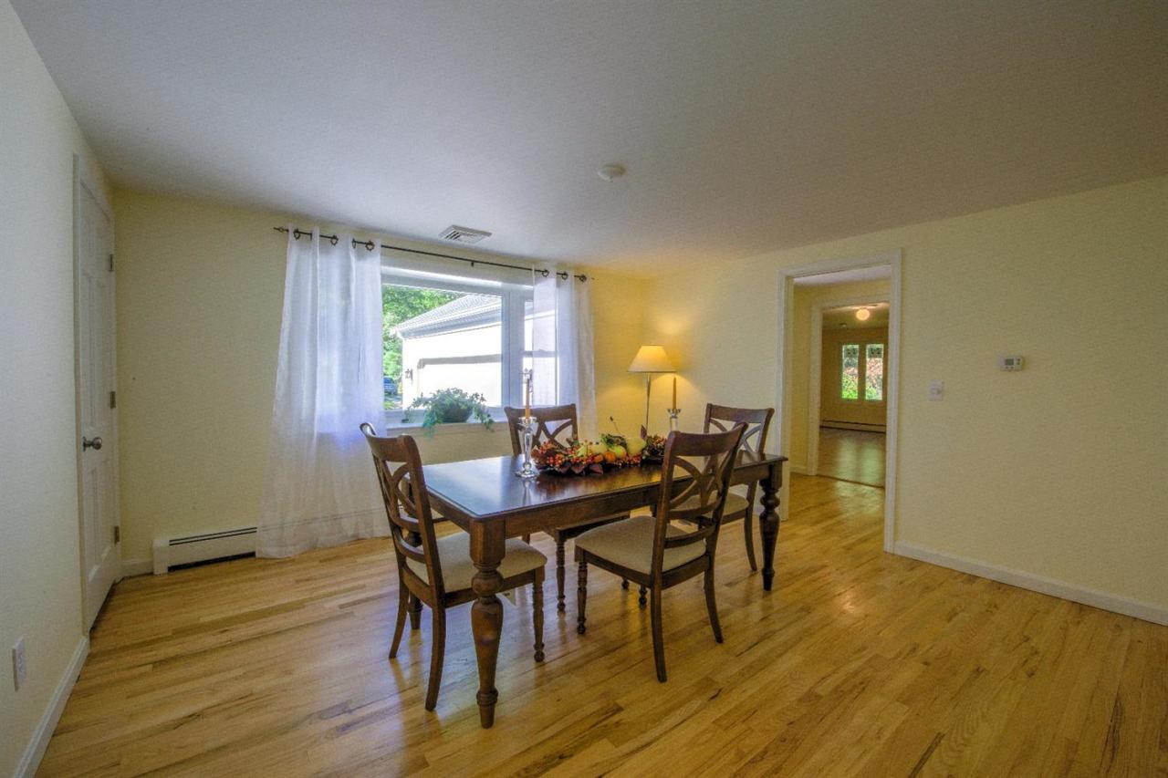 90 Ralyn Road Cotuit, MA 02635 - Photo 8 of 29 a view of a dining room with furniture and wooden floor