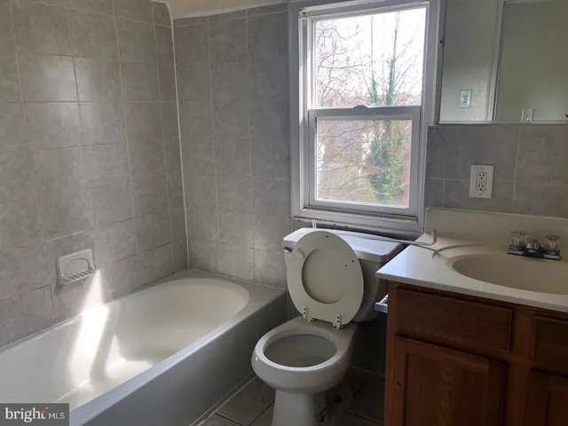a bathroom with a sink a toilet and a bathtub