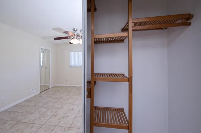 a view of walk in closet with white walls