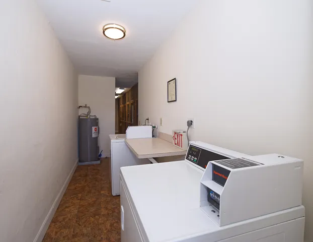 a large kitchen with kitchen island granite countertop a stove sink and cabinets