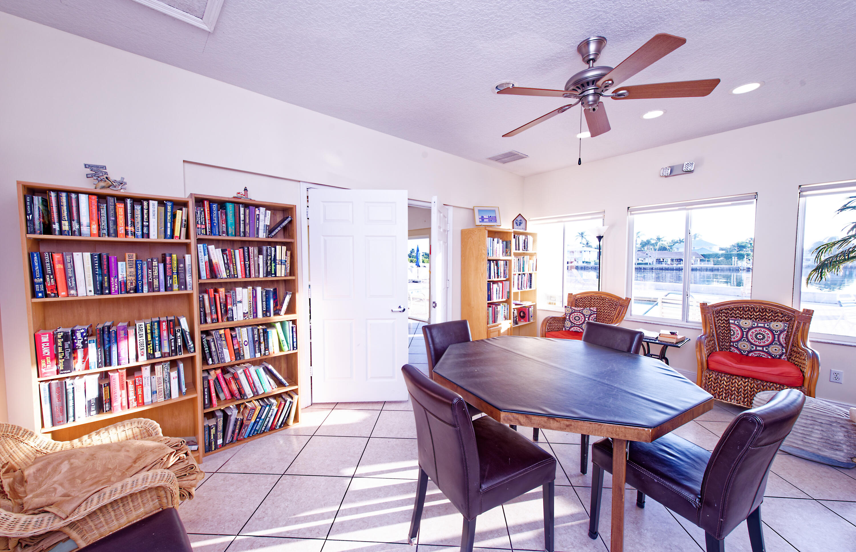632 Snug Harbor Drive, Unit D15 Boynton Beach, FL 33435 - Photo 24 of 50 a view of a dining room with furniture and a book shelf