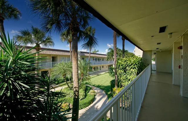 a view of a house with backyard porch and sitting area