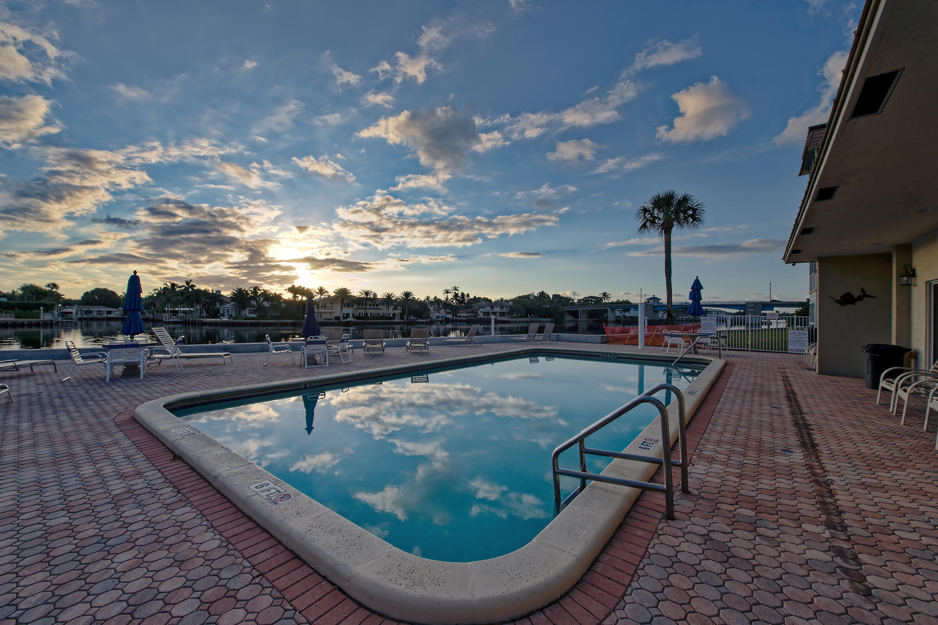 632 Snug Harbor Drive, Unit D15 Boynton Beach, FL 33435 - Photo 37 of 50 a view of a swimming pool with a lounge chair