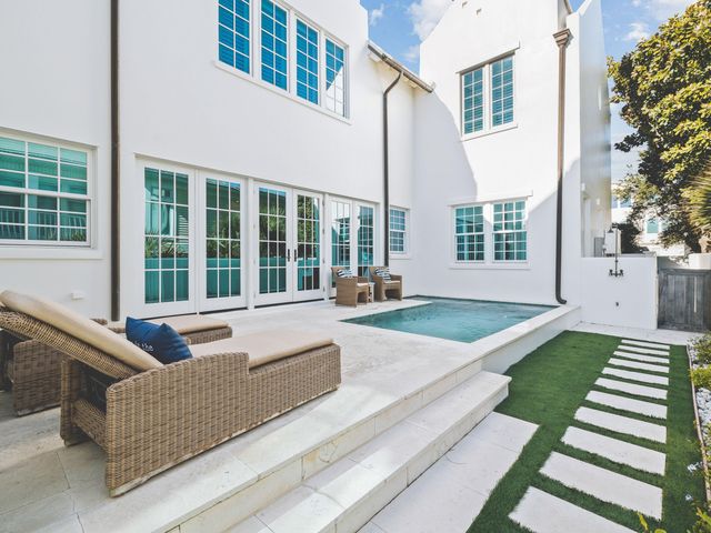 a view of house with yard and outdoor seating