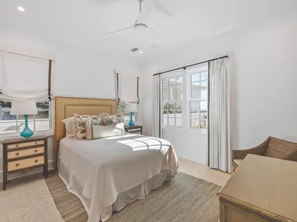 a bedroom with a large bed and a chandelier