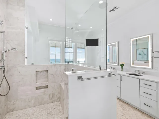 a bathroom with a double vanity sink a mirror and a bathtub