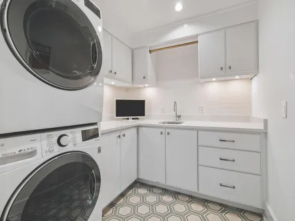 a utility room with sink dryer and washer