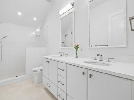 a bathroom with a granite countertop sink mirror and toilet
