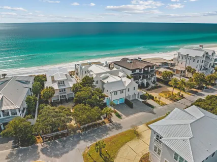 an aerial view of residential houses with outdoor space and swimming pool