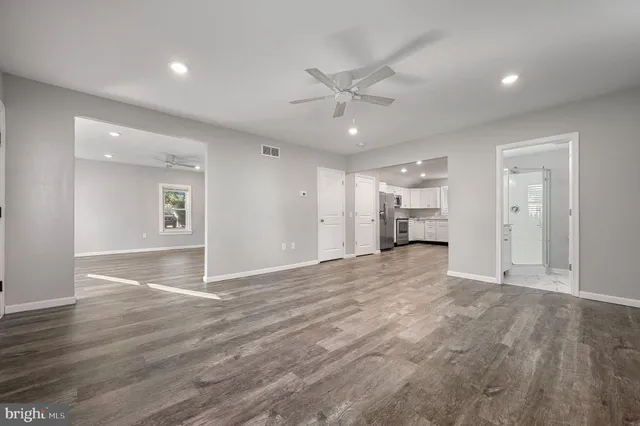 a view of empty room with wooden floor