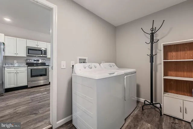 a utility room with cabinets washer and dryer