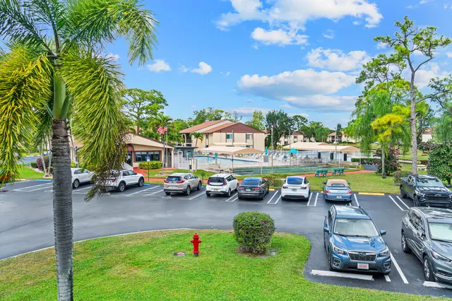 a cars parked in front of a house with a garden