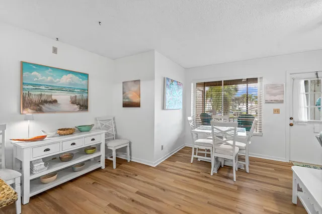 a view of a workspace with furniture and wooden floor