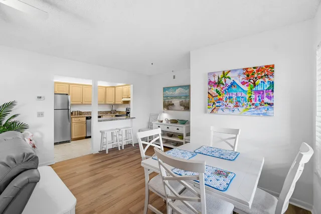 a living room with furniture and painting on the wall