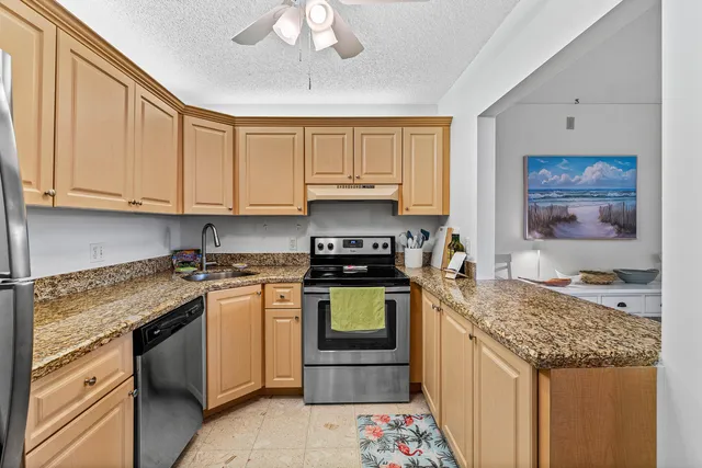 a kitchen with stainless steel appliances granite countertop a stove and a sink