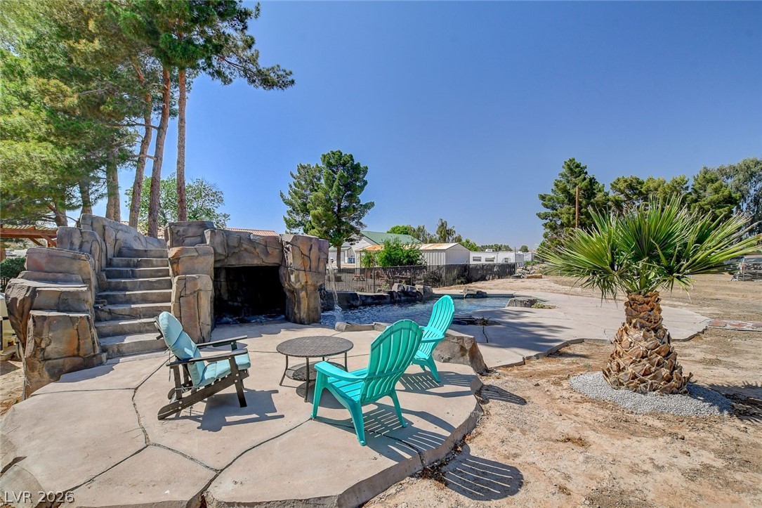 3765 Berkeley Street Logandale, NV 89021 - Photo 76 of 87 This captivating outdoor area offers a refreshing pool with a grotto and a waterfall feature.