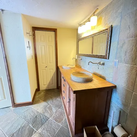 a bathroom with a sink a mirror and a bathtub