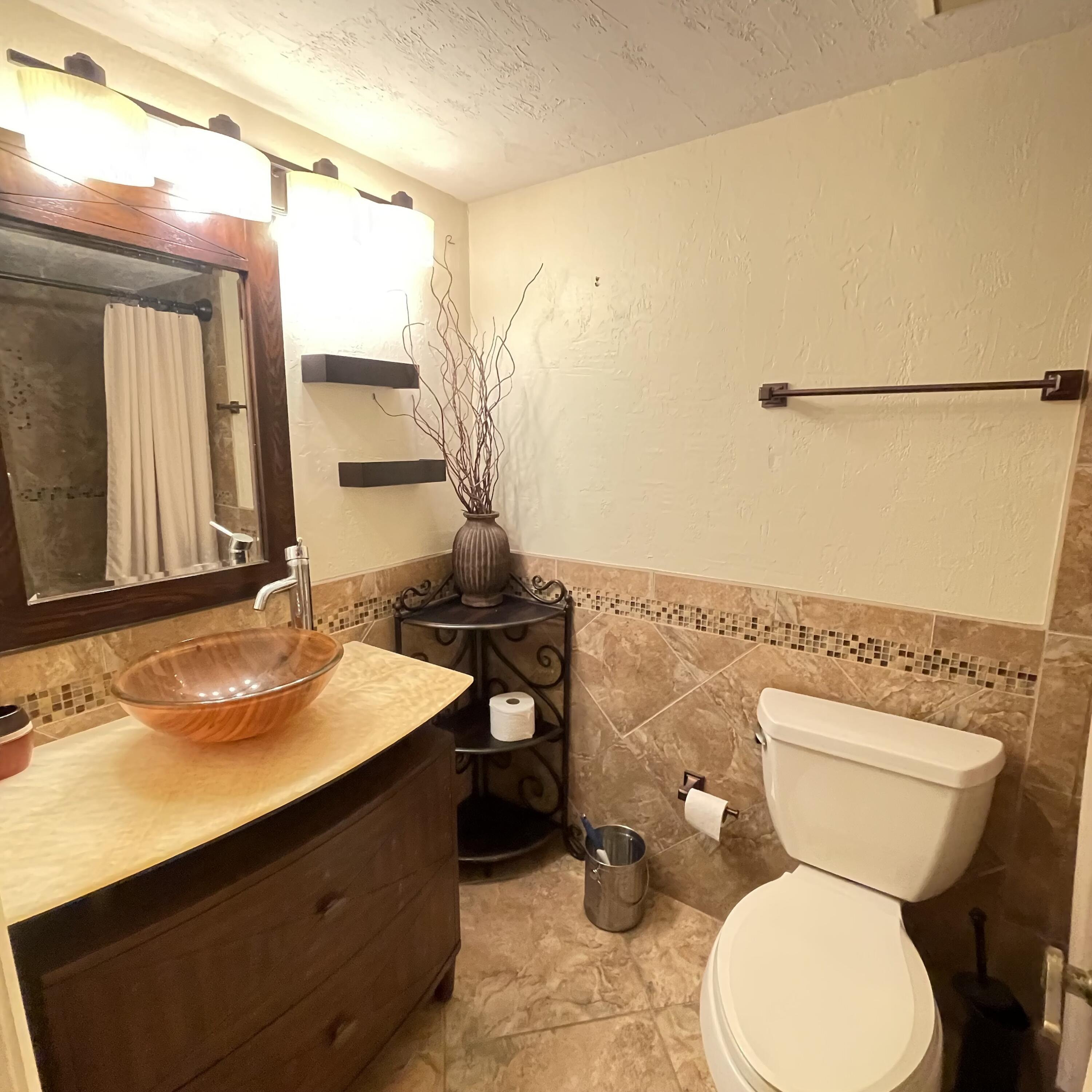 1540 Riverside Drive, Unit 14 Titusville, FL 32780 - Photo 22 of 29 a bathroom with a toilet sink and mirror