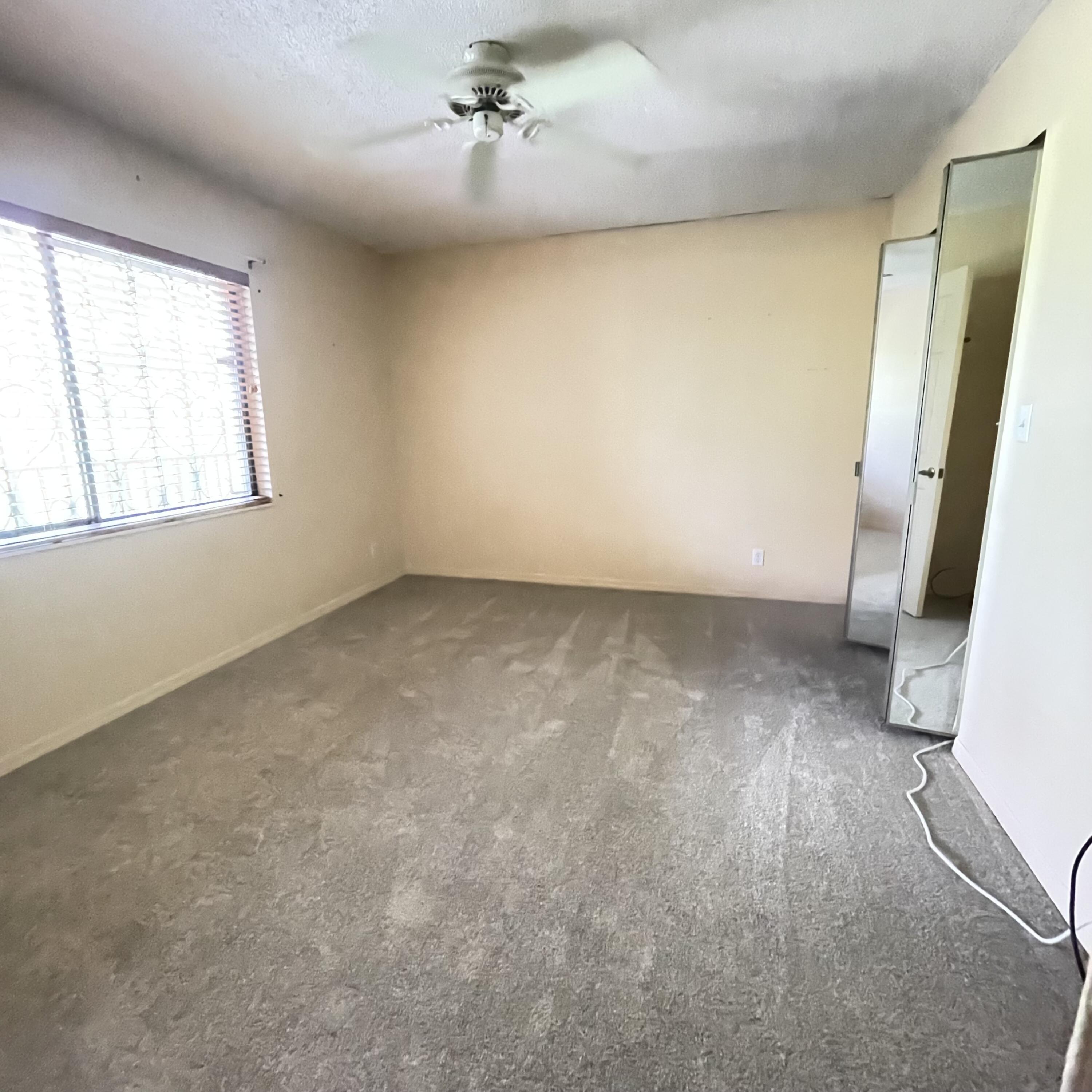 1540 Riverside Drive, Unit 14 Titusville, FL 32780 - Photo 23 of 29 wooden floor in an empty room with a window