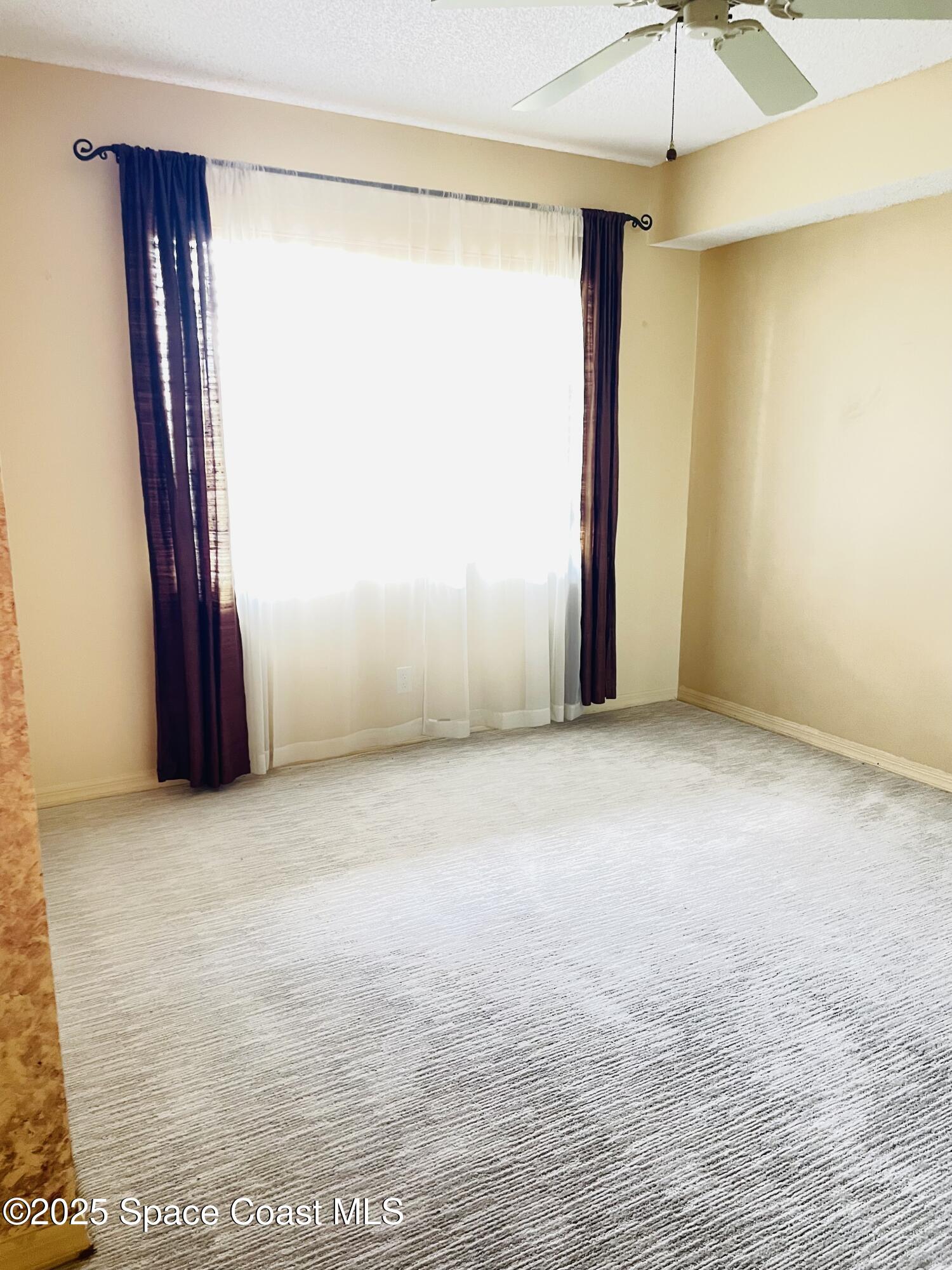 1540 Riverside Drive, Unit 14 Titusville, FL 32780 - Photo 27 of 29 a view of an empty room with a window