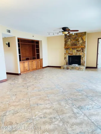 a view of an empty room with a fireplace