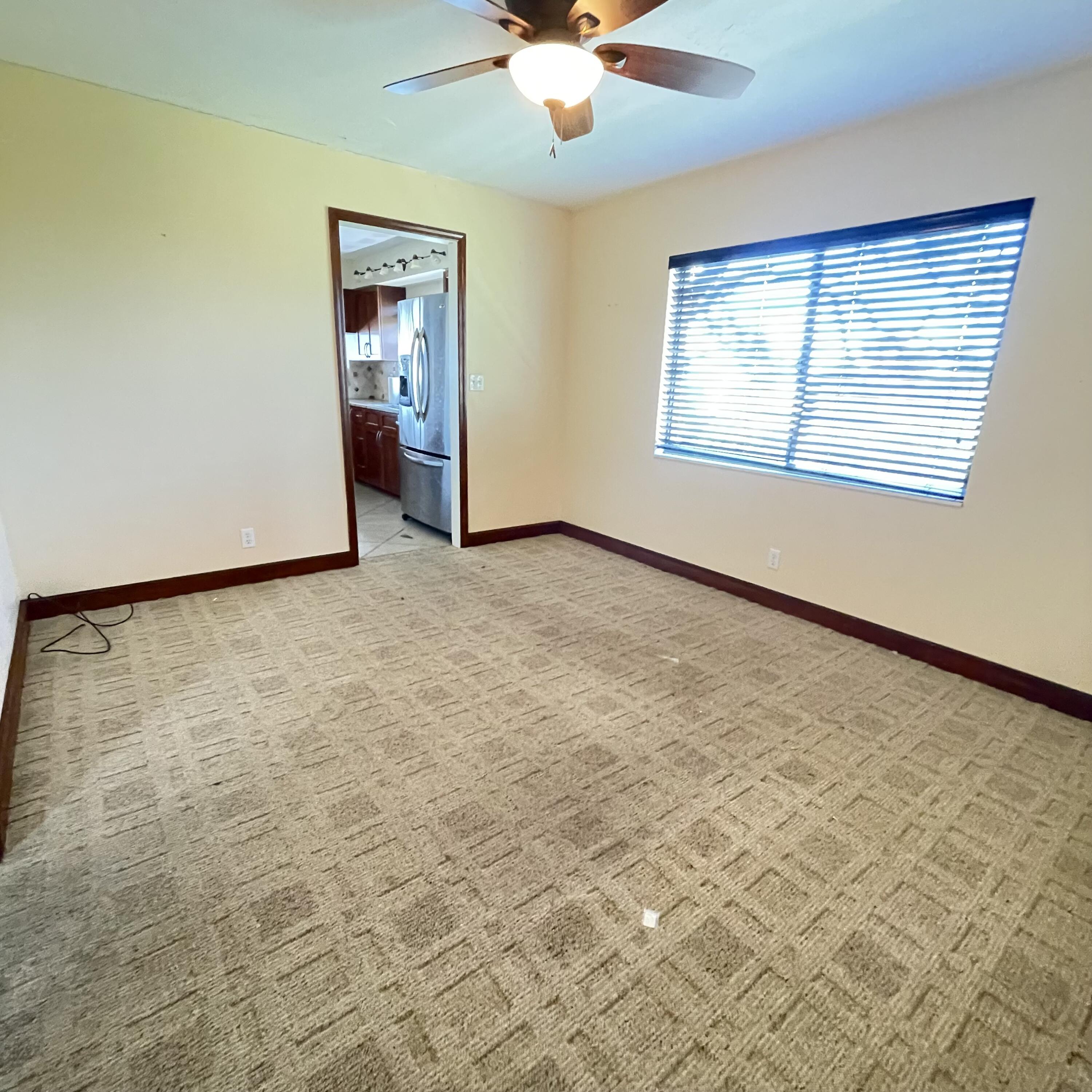 1540 Riverside Drive, Unit 14 Titusville, FL 32780 - Photo 10 of 29 an empty room with windows and fan