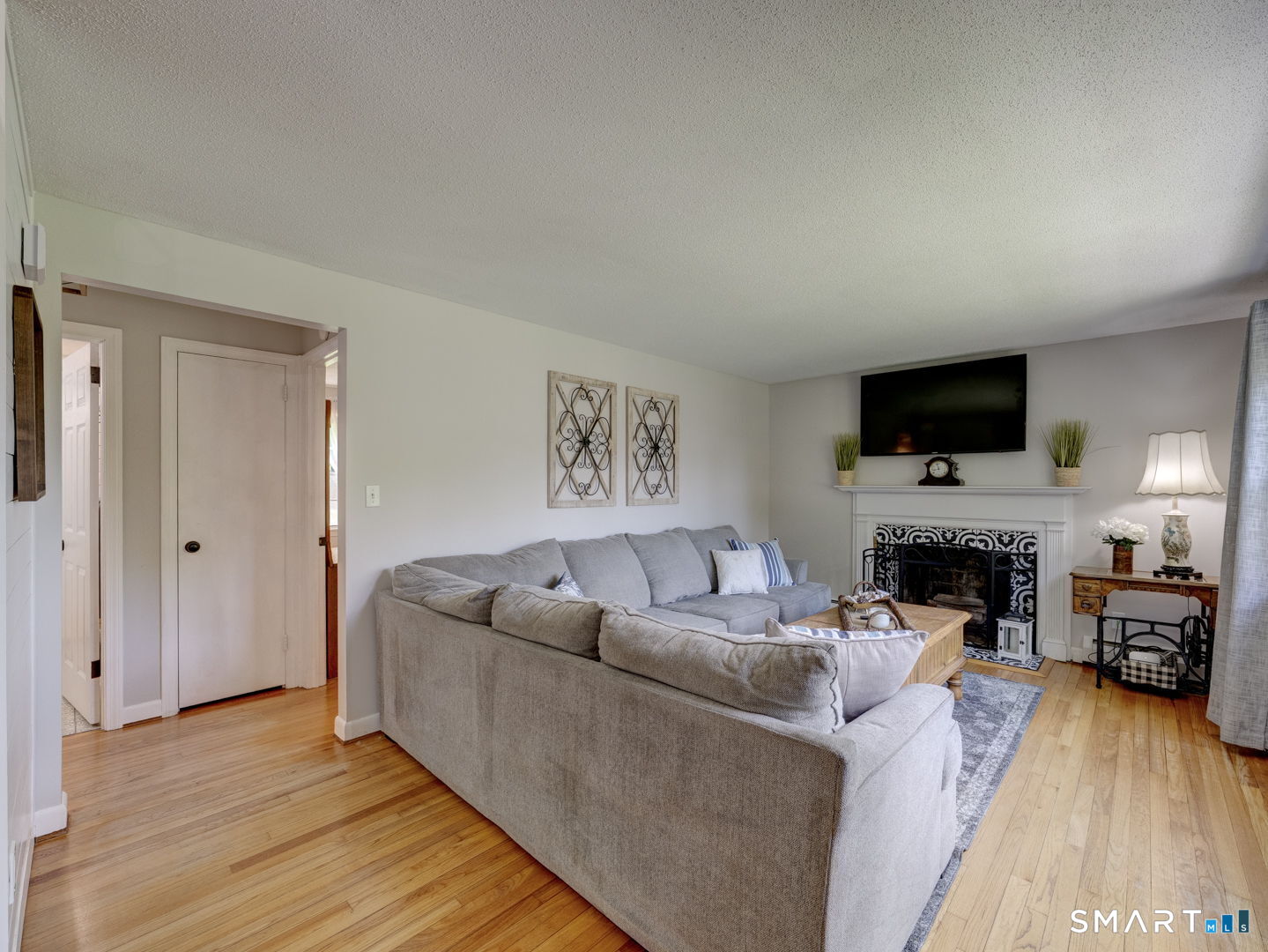 39 Freedom Drive Canton, CT 06019 - Photo 6 of 37 a living room with furniture a fireplace and a flat screen tv