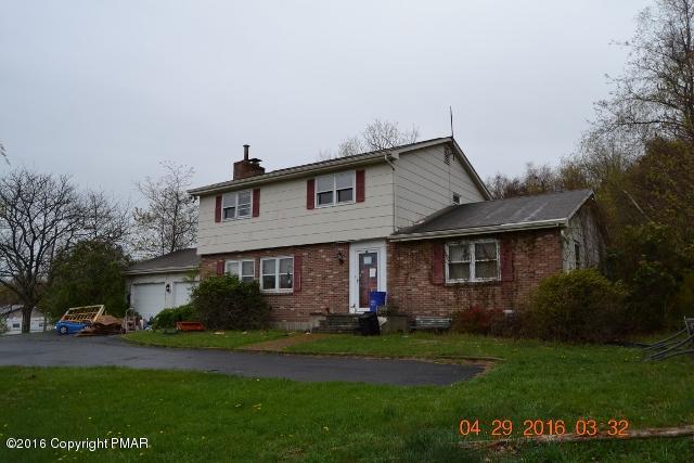 159 Doney Road Gilbert, PA 18331 - Photo 2 of 14 a front view of a house with a garden and yard