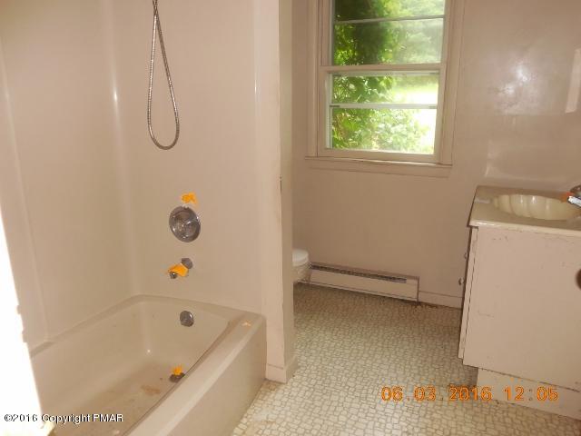 159 Doney Road Gilbert, PA 18331 - Photo 10 of 14 a bathroom with a tub a window and a shower